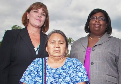 Attorneys Lisa Carmona, left, and Tequisha Myles, right, with plaintiff Magdalena Diego.