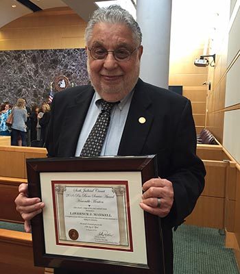 Larry Markell holding certificate