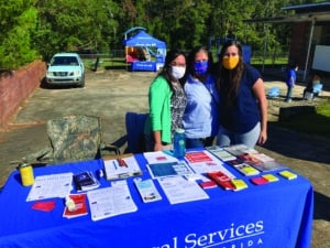 Daniela Donoso, right, with Legal Services of North Florida staff at a community event